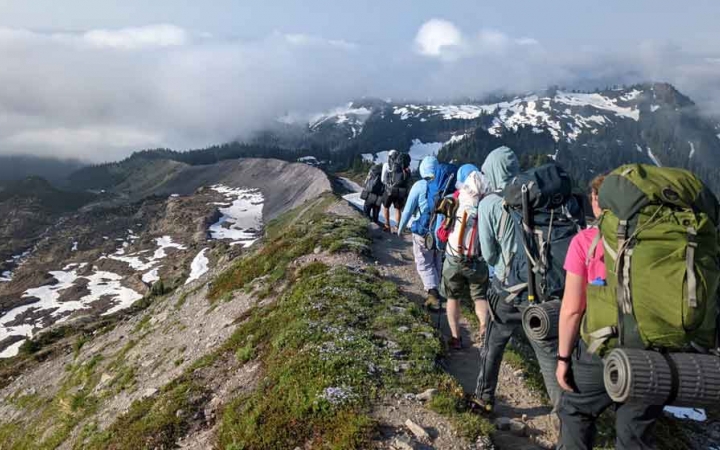 a group of students on a mountaineering course traverse a mountainous landscape